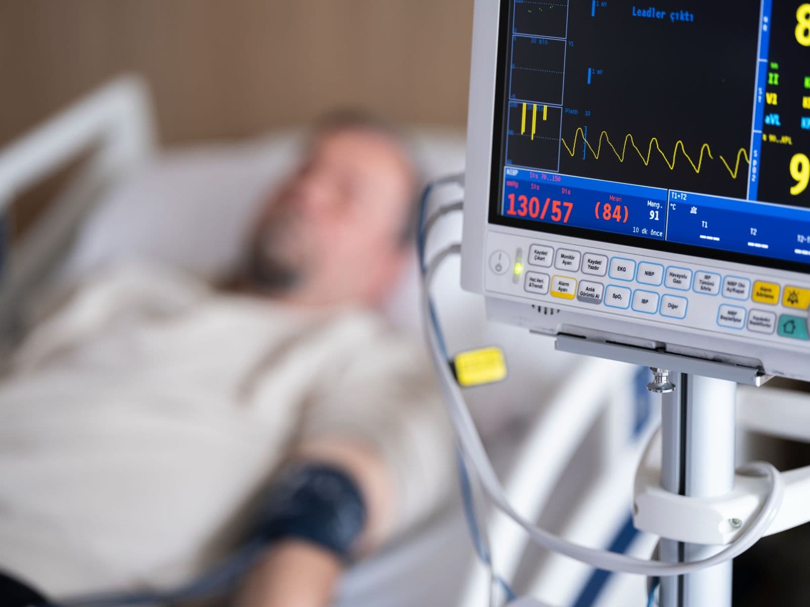 Bedside blood-pressure monitor showing a reading